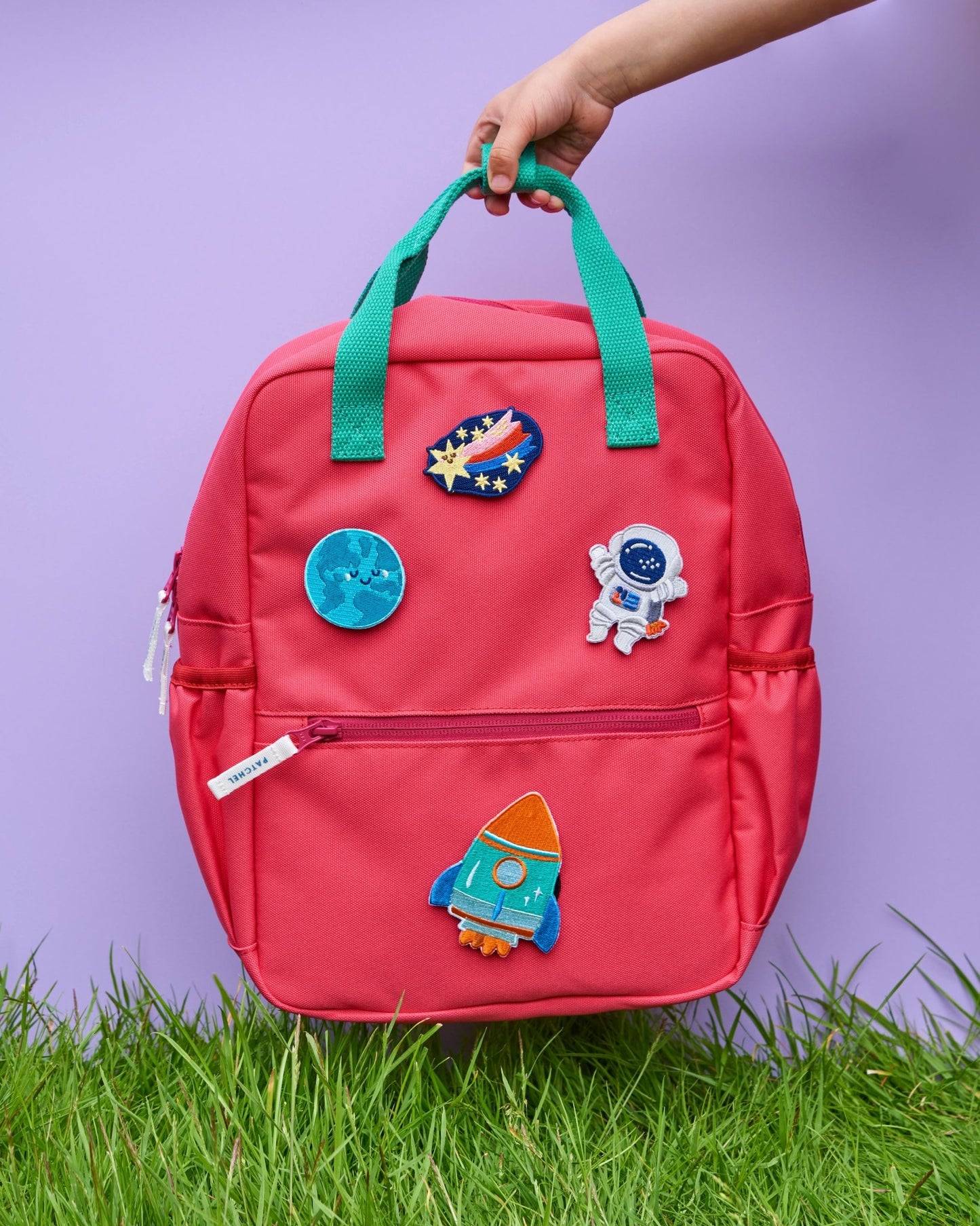 Watermelon Pink Patchel kids' rucksack with Space Explorers patches featuring a rocket, astronaut, shooting star and Earth
